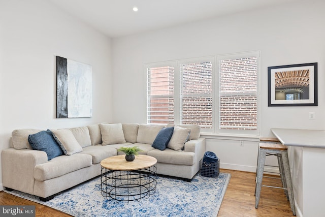 living room with plenty of natural light and light hardwood / wood-style floors