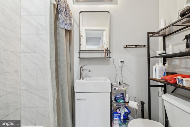 bathroom with vanity, toilet, and walk in shower