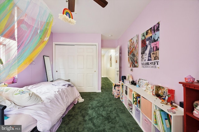 carpeted bedroom featuring ceiling fan and a closet