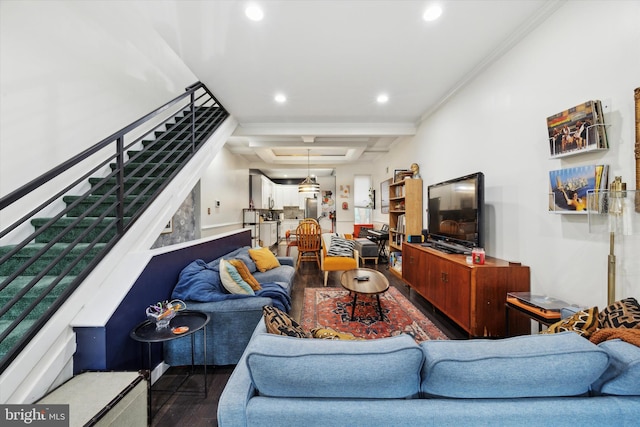 living room featuring beam ceiling, dark hardwood / wood-style flooring, and ornamental molding