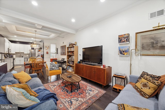 living room featuring beam ceiling, ornamental molding, and dark wood-type flooring