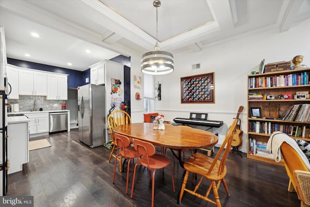 dining room with crown molding, dark wood-type flooring, sink, beam ceiling, and an inviting chandelier