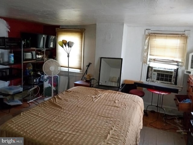 bedroom featuring cooling unit and hardwood / wood-style flooring