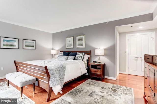 bedroom featuring light hardwood / wood-style floors and ornamental molding