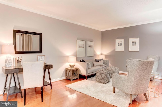 living room with light hardwood / wood-style flooring and ornamental molding