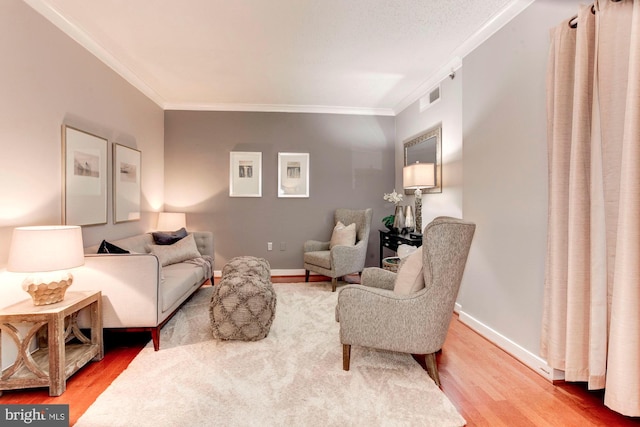 sitting room featuring crown molding and wood-type flooring