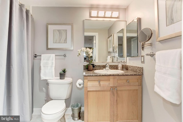 bathroom featuring tile patterned flooring, vanity, and toilet