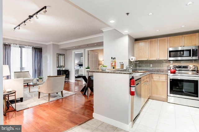 kitchen with light stone countertops, stainless steel appliances, light hardwood / wood-style flooring, light brown cabinetry, and ornamental molding