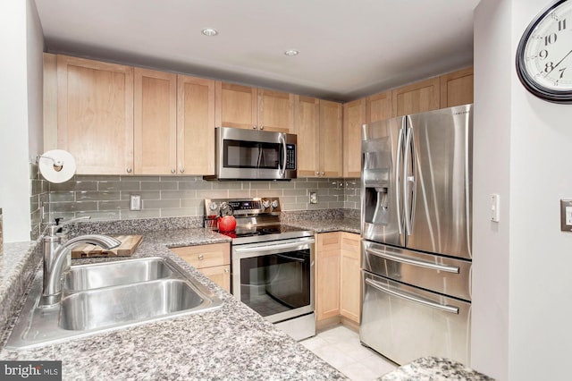 kitchen featuring decorative backsplash, light brown cabinets, sink, and appliances with stainless steel finishes