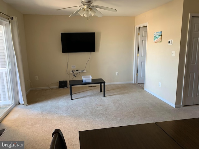 unfurnished living room featuring ceiling fan and light colored carpet