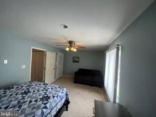 bedroom featuring ceiling fan and light carpet