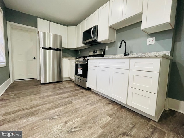 kitchen featuring white cabinets and appliances with stainless steel finishes