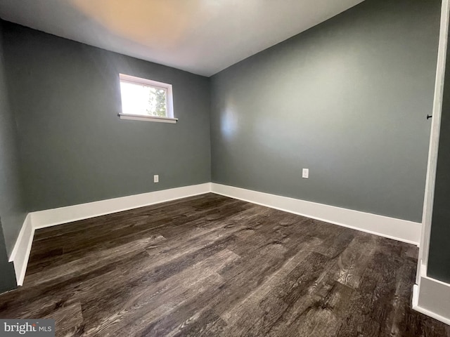 unfurnished room featuring dark wood-type flooring