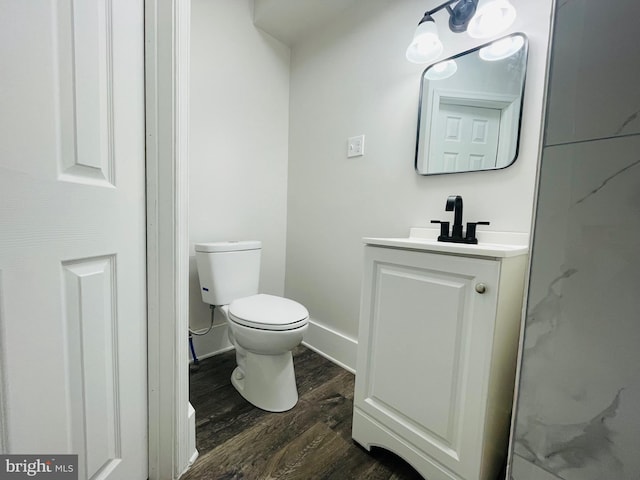 bathroom with vanity, wood-type flooring, and toilet