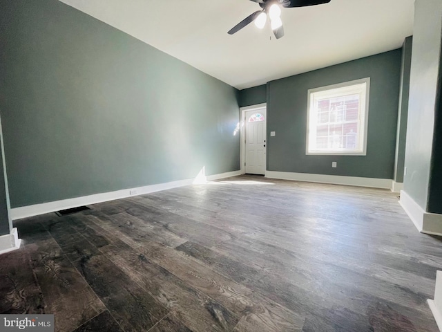 unfurnished room with ceiling fan and dark hardwood / wood-style flooring