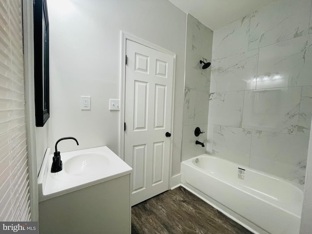 bathroom with tiled shower / bath, vanity, and hardwood / wood-style flooring