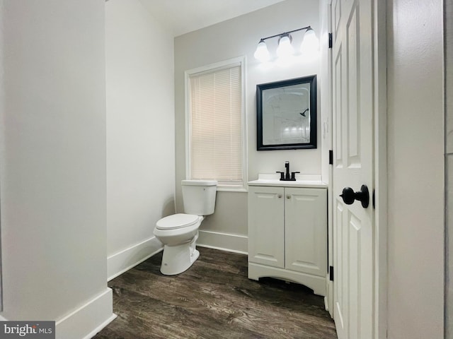 bathroom with vanity, wood-type flooring, and toilet