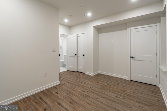 empty room featuring dark hardwood / wood-style flooring