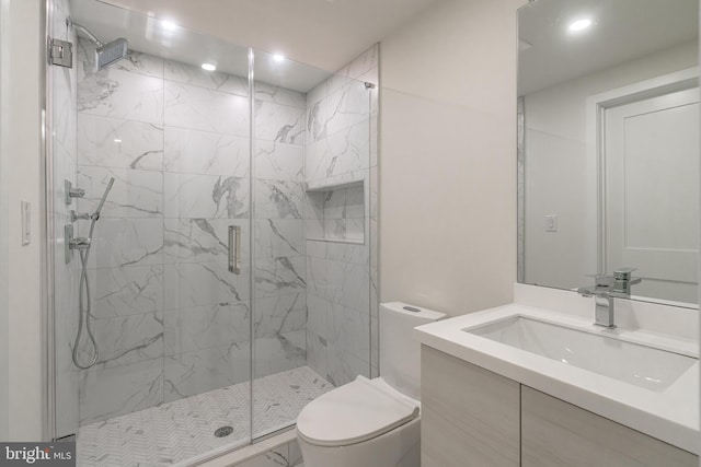 bathroom with vanity, toilet, and a shower with door