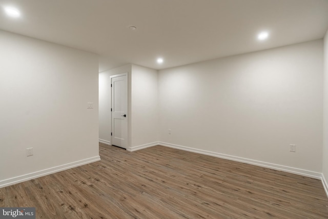 empty room with dark hardwood / wood-style flooring