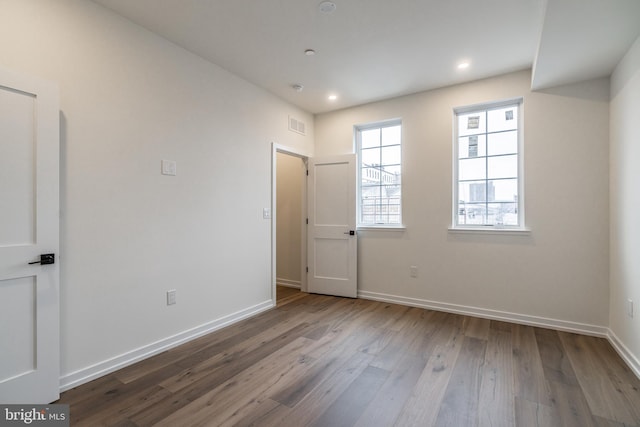 spare room with hardwood / wood-style flooring