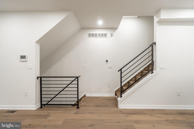 stairway with hardwood / wood-style floors