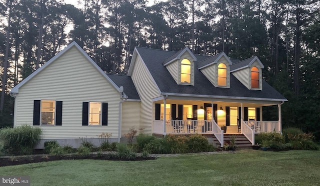 view of front of house with covered porch and a front yard