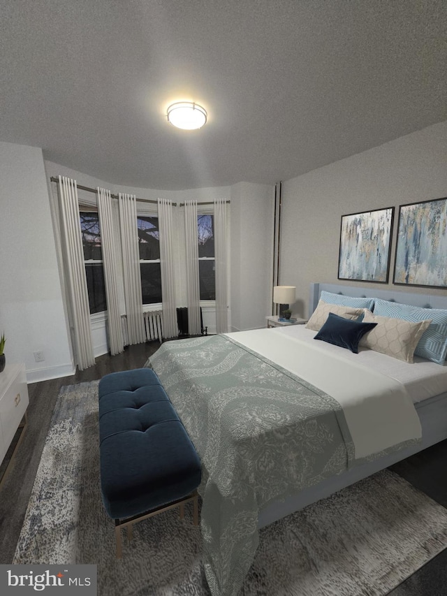 bedroom featuring a textured ceiling and dark wood-type flooring