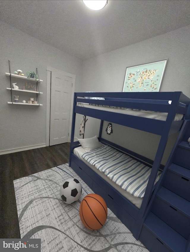 bedroom featuring dark hardwood / wood-style flooring and a textured ceiling