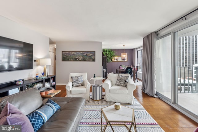 living room featuring hardwood / wood-style flooring and a notable chandelier