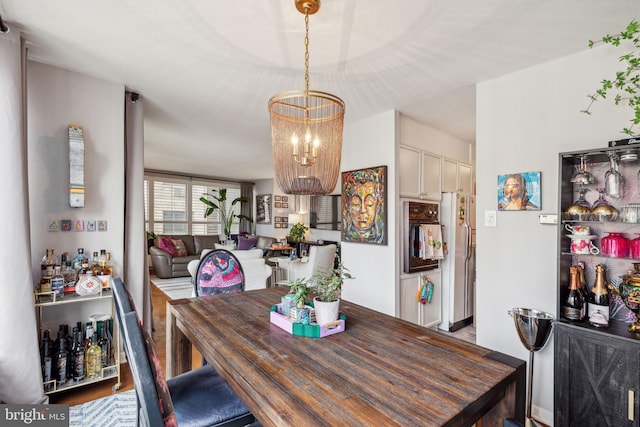 dining room featuring hardwood / wood-style floors and a chandelier