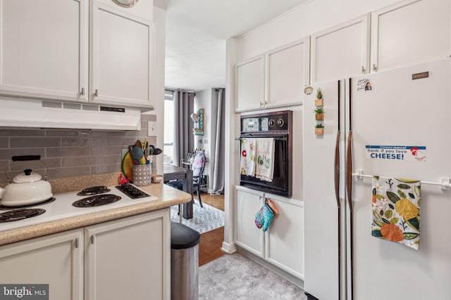 kitchen featuring light hardwood / wood-style floors, decorative backsplash, white cabinetry, and white appliances