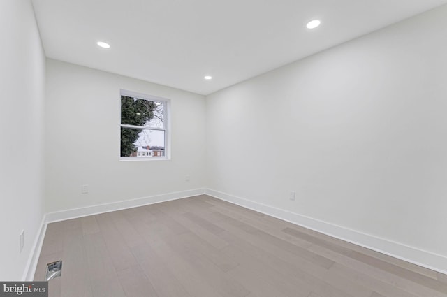 spare room with light hardwood / wood-style flooring