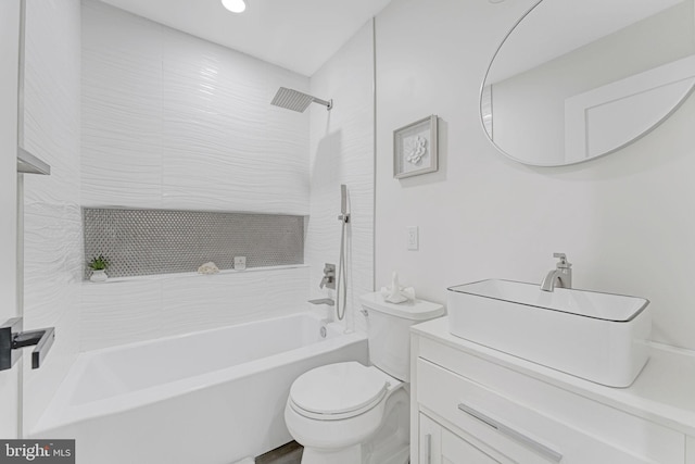 full bathroom featuring vanity, toilet, and tiled shower / bath