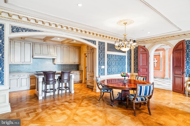 dining space featuring a chandelier, crown molding, and light parquet floors