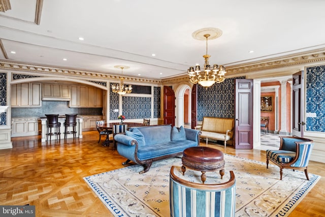 living room featuring crown molding, light parquet flooring, and a notable chandelier