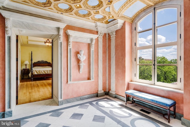 interior space with light hardwood / wood-style floors, a wealth of natural light, and crown molding