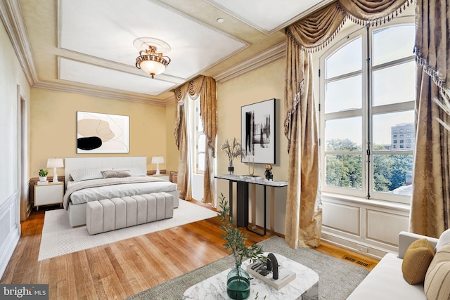 bedroom featuring hardwood / wood-style floors and ornamental molding