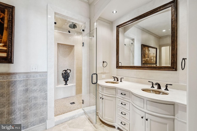 bathroom with vanity, an enclosed shower, crown molding, and tile walls