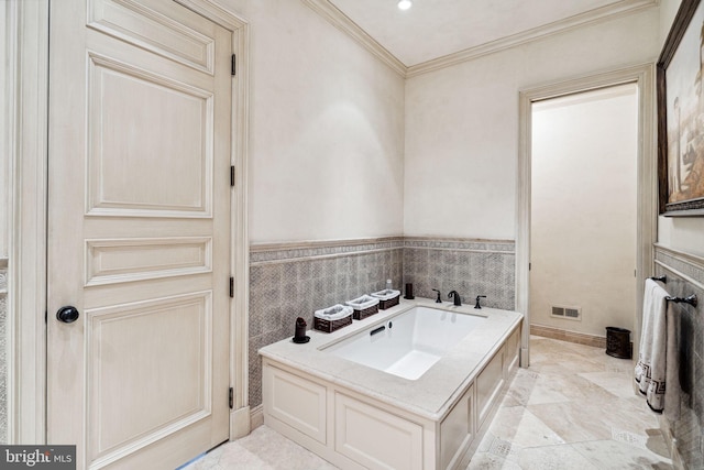 bathroom with a bath, tile walls, and ornamental molding