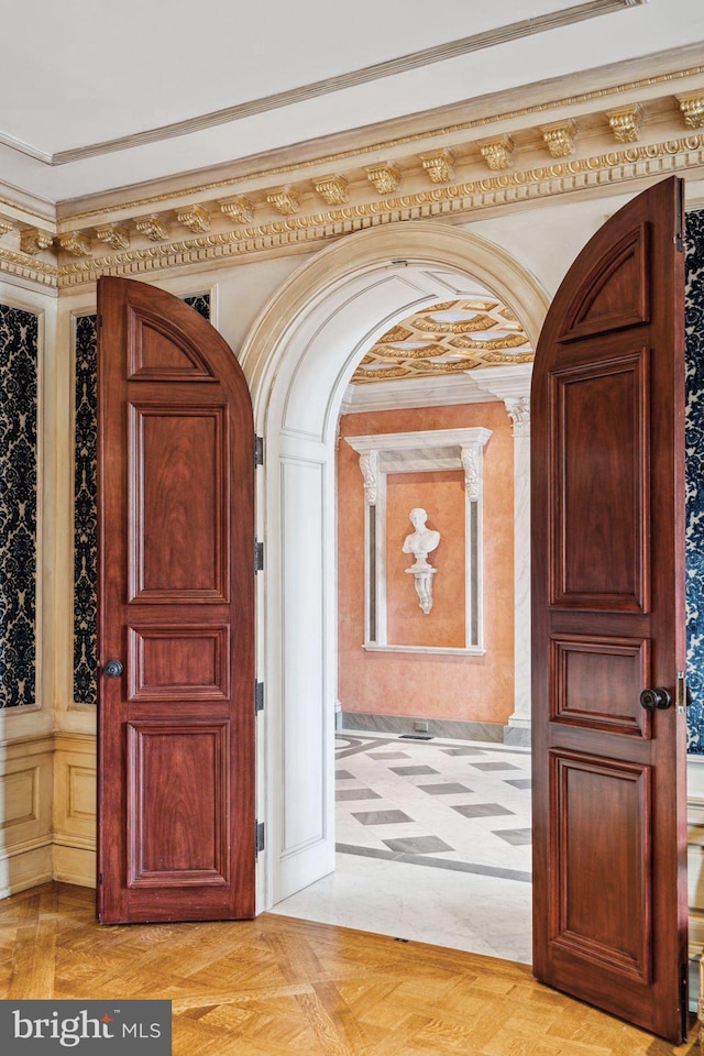 interior space featuring light parquet floors and ornamental molding