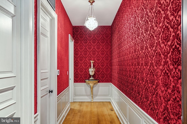 doorway to outside with light hardwood / wood-style flooring and a chandelier