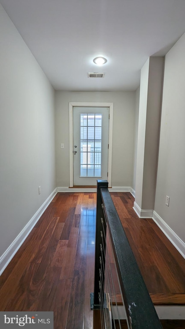 doorway with dark hardwood / wood-style flooring