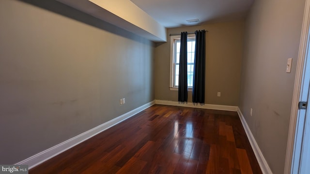 empty room with dark hardwood / wood-style floors