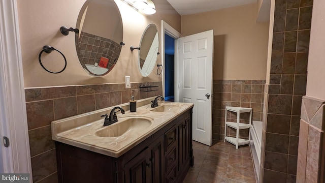 bathroom with vanity and tile walls