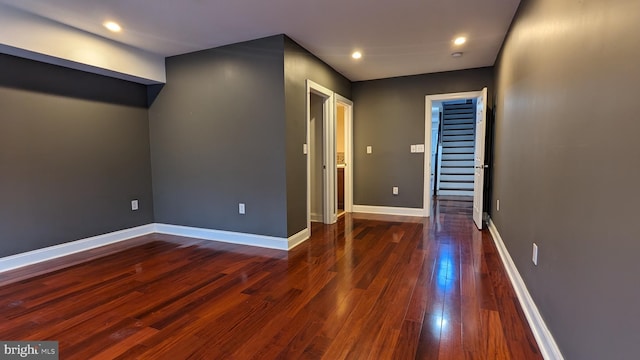 unfurnished room with dark hardwood / wood-style floors