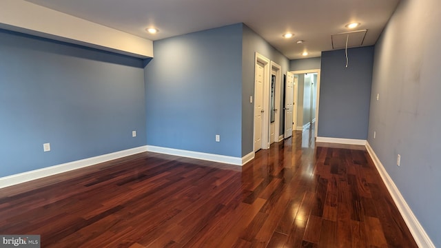 spare room with dark hardwood / wood-style floors