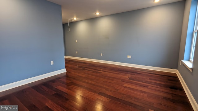 spare room featuring dark hardwood / wood-style flooring