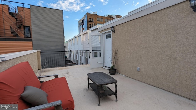 view of patio featuring a balcony