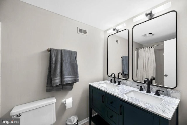 bathroom featuring toilet and vanity